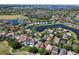 Expansive aerial view of a community with houses, ponds, trees, and a golf course at 13643 Budworth Cir, Orlando, FL 32832