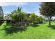 Wide backyard with lush lawn, privacy landscaping, and an iron fence at 13643 Budworth Cir, Orlando, FL 32832
