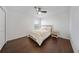 Cozy bedroom with hardwood floors, a ceiling fan and a comfortable queen bed at 13643 Budworth Cir, Orlando, FL 32832