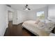 Bedroom with dark wood floor, ceiling fan, and natural light from the window at 13643 Budworth Cir, Orlando, FL 32832