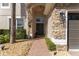 Inviting entryway featuring a stone archway, brick pathway, and lush landscaping, creating a warm welcome at 13643 Budworth Cir, Orlando, FL 32832