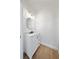 Tastefully updated half bath with white vanity, stylish lighting, and wood look flooring at 13643 Budworth Cir, Orlando, FL 32832