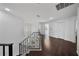 Upstairs hallway with hardwood floors, iron railing, and neutral walls at 13643 Budworth Cir, Orlando, FL 32832