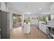 Modern kitchen featuring stainless steel appliances, white cabinetry, and an island with views of outdoor living space at 13643 Budworth Cir, Orlando, FL 32832