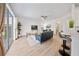 Open-concept living area with large windows, modern furnishings, and seamless flow from kitchen and outdoor spaces at 13643 Budworth Cir, Orlando, FL 32832