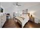 Bright main bedroom suite with wood floors, ceiling fan, and an adjacent office space at 13643 Budworth Cir, Orlando, FL 32832