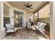Relaxing covered patio with neutral toned furniture, a ceiling fan, and brick pavers at 13643 Budworth Cir, Orlando, FL 32832