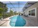 Gorgeous kidney shaped screened in pool with brick paver deck and lush landscaping at 13643 Budworth Cir, Orlando, FL 32832
