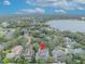 An aerial view showing the property's location within a residential neighborhood near a lake at 142 Stone Hill Dr, Maitland, FL 32751
