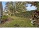 Enjoy the private backyard with a beautiful wall of ivy, mature trees and verdant lawn at 142 Stone Hill Dr, Maitland, FL 32751