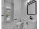 Modern bathroom with sleek fixtures, a minimalist vanity, and easy access to the outdoor pool area; bright and functional at 142 Stone Hill Dr, Maitland, FL 32751
