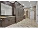Luxurious bathroom showcasing custom vanities, elegant finishes, and a spacious walk-in shower with unique stonework at 142 Stone Hill Dr, Maitland, FL 32751