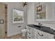 Bathroom featuring a vanity with a black countertop, a toilet, and glass-enclosed shower at 142 Stone Hill Dr, Maitland, FL 32751