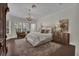 Serene bedroom with a chandelier, large windows, and a cozy sitting area; providing a peaceful retreat at 142 Stone Hill Dr, Maitland, FL 32751