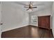 Bedroom with hardwood floors, a window, ceiling fan, and a dark wood dresser at 142 Stone Hill Dr, Maitland, FL 32751