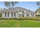 Beautiful two-story home features a manicured front lawn, a tile roof, and lush landscaping at 142 Stone Hill Dr, Maitland, FL 32751