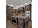 Spacious kitchen features dark wood cabinetry, a center island, and stainless steel appliances at 142 Stone Hill Dr, Maitland, FL 32751