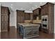 Large kitchen featuring dark wood cabinets, stainless steel appliances, and a center island with sink at 142 Stone Hill Dr, Maitland, FL 32751