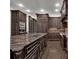 Spacious kitchen with custom cabinets, granite countertops, stainless appliances, and a center island at 142 Stone Hill Dr, Maitland, FL 32751