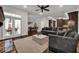Open-concept living space with a view into the kitchen, featuring stylish furnishings and plenty of natural light at 142 Stone Hill Dr, Maitland, FL 32751