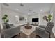 Cozy living room with comfortable seating, neutral decor, and lots of natural light; ideal for relaxation at 142 Stone Hill Dr, Maitland, FL 32751