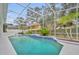 Screened-in pool area featuring a spa and well-maintained landscaping at 142 Stone Hill Dr, Maitland, FL 32751