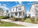 Well-maintained two-story home featuring a covered front porch and mature landscaping at 14366 Lanikai Beach Dr, Orlando, FL 32827