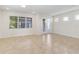 Open living room featuring tile floors, lots of natural light, and French doors at 14366 Lanikai Beach Dr, Orlando, FL 32827