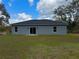 The backyard features a grassy area, sliding glass doors, and a freshly installed roof at 16904 Sw 30Th Avenue Rd, Ocala, FL 34473