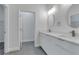 Bathroom showcasing a double vanity with modern fixtures and quartz countertops at 16904 Sw 30Th Avenue Rd, Ocala, FL 34473