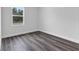 Bright bedroom featuring a window overlooking green landscape, modern flooring, and neutral wall color at 16904 Sw 30Th Avenue Rd, Ocala, FL 34473