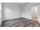 This bedroom features wood flooring, a large window, and plenty of natural light at 16904 Sw 30Th Avenue Rd, Ocala, FL 34473