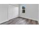 Cozy bedroom featuring a large window and a spacious closet with white sliding doors at 16904 Sw 30Th Avenue Rd, Ocala, FL 34473