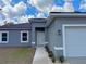 Close-up of home exterior with a two-car garage, showcasing the landscaped walkway to the front door at 16904 Sw 30Th Avenue Rd, Ocala, FL 34473