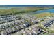 An aerial view of a community next to a lake, highlighting well-maintained homes and green spaces at 1702 Reflection Ln, St Cloud, FL 34771