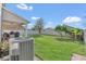Spacious backyard with lush green grass, a white fence, and a covered patio at 1702 Reflection Ln, St Cloud, FL 34771