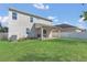 Wide view of the backyard featuring the home's exterior and covered patio at 1702 Reflection Ln, St Cloud, FL 34771