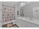 Clean bathroom features a double sink vanity, framed mirror, and neutral colored tile floors at 1702 Reflection Ln, St Cloud, FL 34771