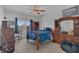Cozy bedroom with natural light, a ceiling fan, and classic wooden furniture at 1702 Reflection Ln, St Cloud, FL 34771