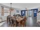 Open-concept dining room with large wooden table, stylish lighting, and seamless access to the living room at 1702 Reflection Ln, St Cloud, FL 34771