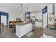 Bright kitchen features white cabinets, stainless steel appliances, and a granite island with pendant lighting at 1702 Reflection Ln, St Cloud, FL 34771