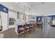 Open-concept kitchen with white cabinetry, granite countertops, stainless appliances, and breakfast bar at 1702 Reflection Ln, St Cloud, FL 34771
