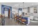 Open-concept kitchen with white cabinetry, granite countertops, stainless appliances, and a breakfast bar at 1702 Reflection Ln, St Cloud, FL 34771