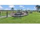 Community playground featuring a playset with slides and benches on a grassy area at 1702 Reflection Ln, St Cloud, FL 34771