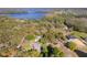 An aerial view shows the property's mature landscaping and proximity to the lake at 17220 Countrybrook Ln, Orlando, FL 32820