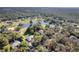 This aerial view showcases the neighborhood's ponds and mature tree coverage at 17220 Countrybrook Ln, Orlando, FL 32820