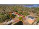 An aerial view showcasing the property boundary with a pool cage and lush greenery at 17220 Countrybrook Ln, Orlando, FL 32820