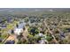 An aerial view featuring multiple homes, a pond, lush green trees, and beautiful natural scenery at 17220 Countrybrook Ln, Orlando, FL 32820