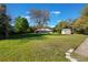 Large backyard with a pool cage and additional storage shed, set against a backdrop of mature trees at 17220 Countrybrook Ln, Orlando, FL 32820