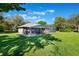 Large yard with a screened pool and outdoor seating provides ample space for relaxation and entertaining at 17220 Countrybrook Ln, Orlando, FL 32820